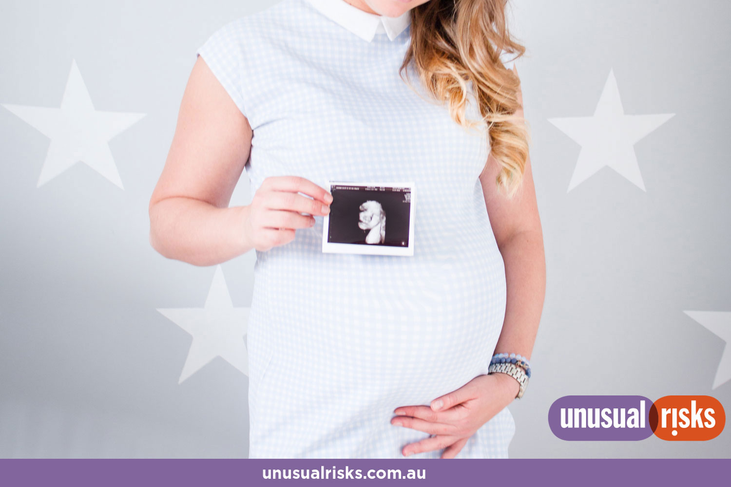 pregnant mother to be holding an ultrasound photo